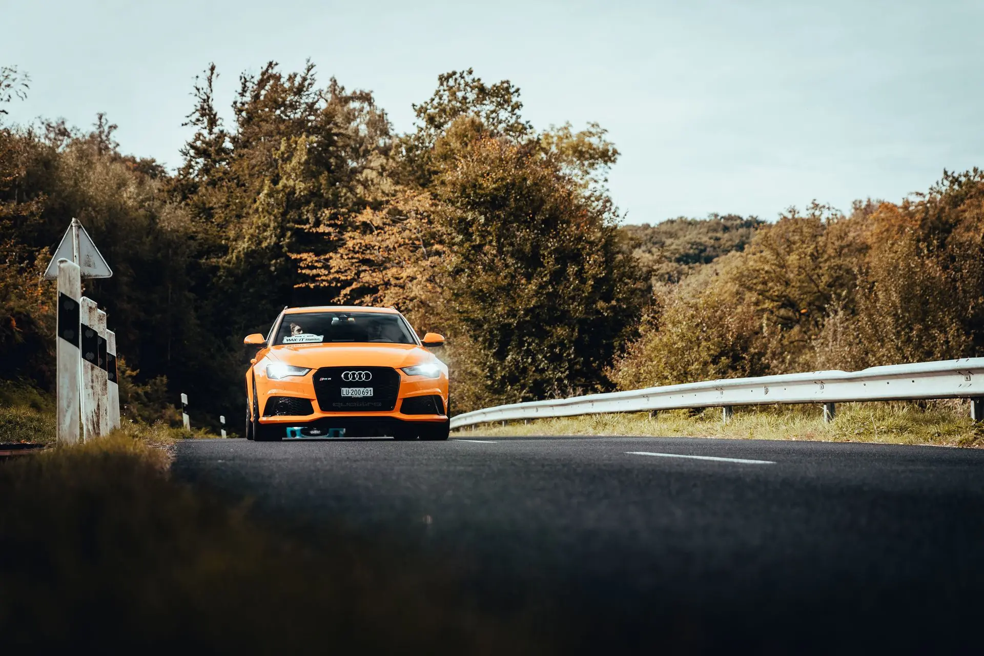Orange Audi RS6 driving down european rouad