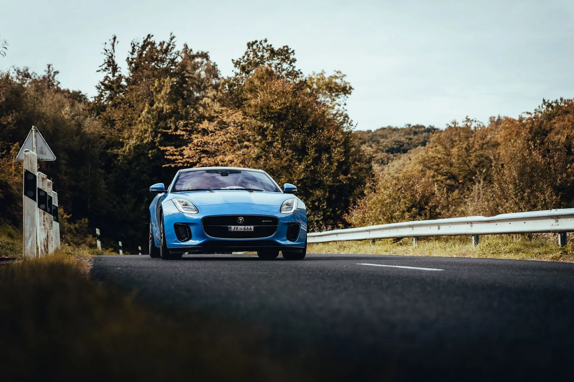Blue Jaguar F-type driving on european roads