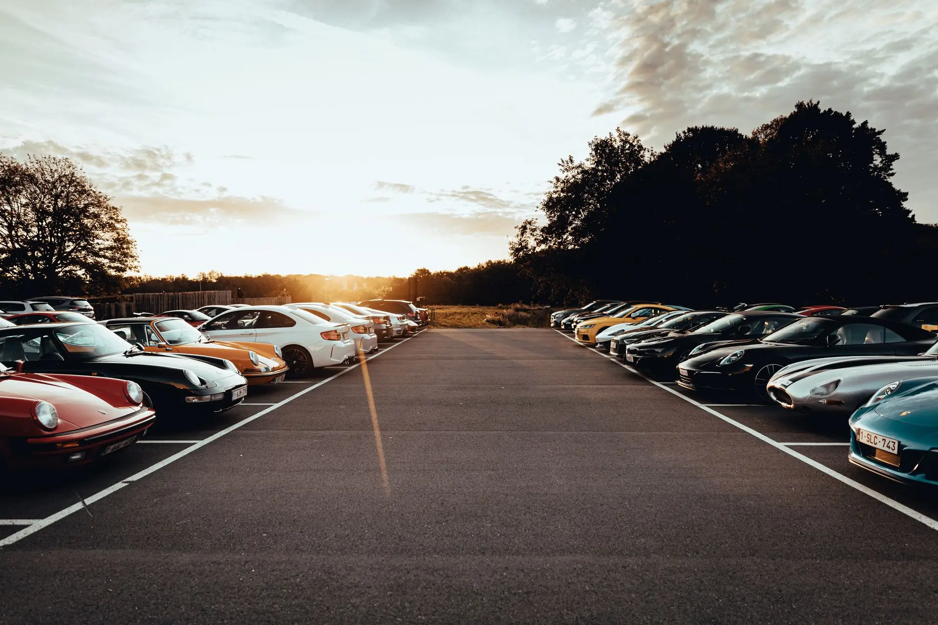 Sports cars parked up with sunset in the back