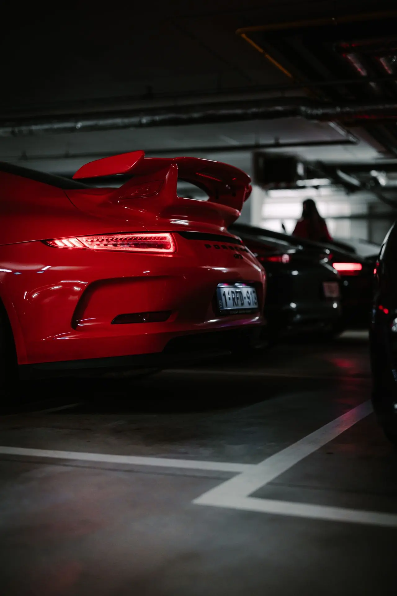 Backside red porsche 911 gt3 parked underground