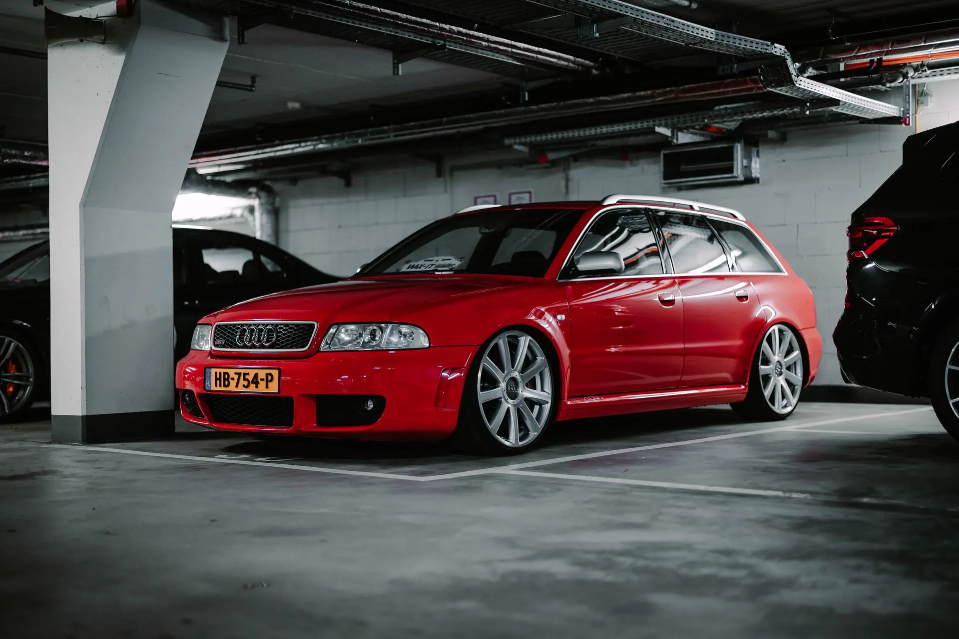 Red Audi RS4 classic parked up underground full body shot