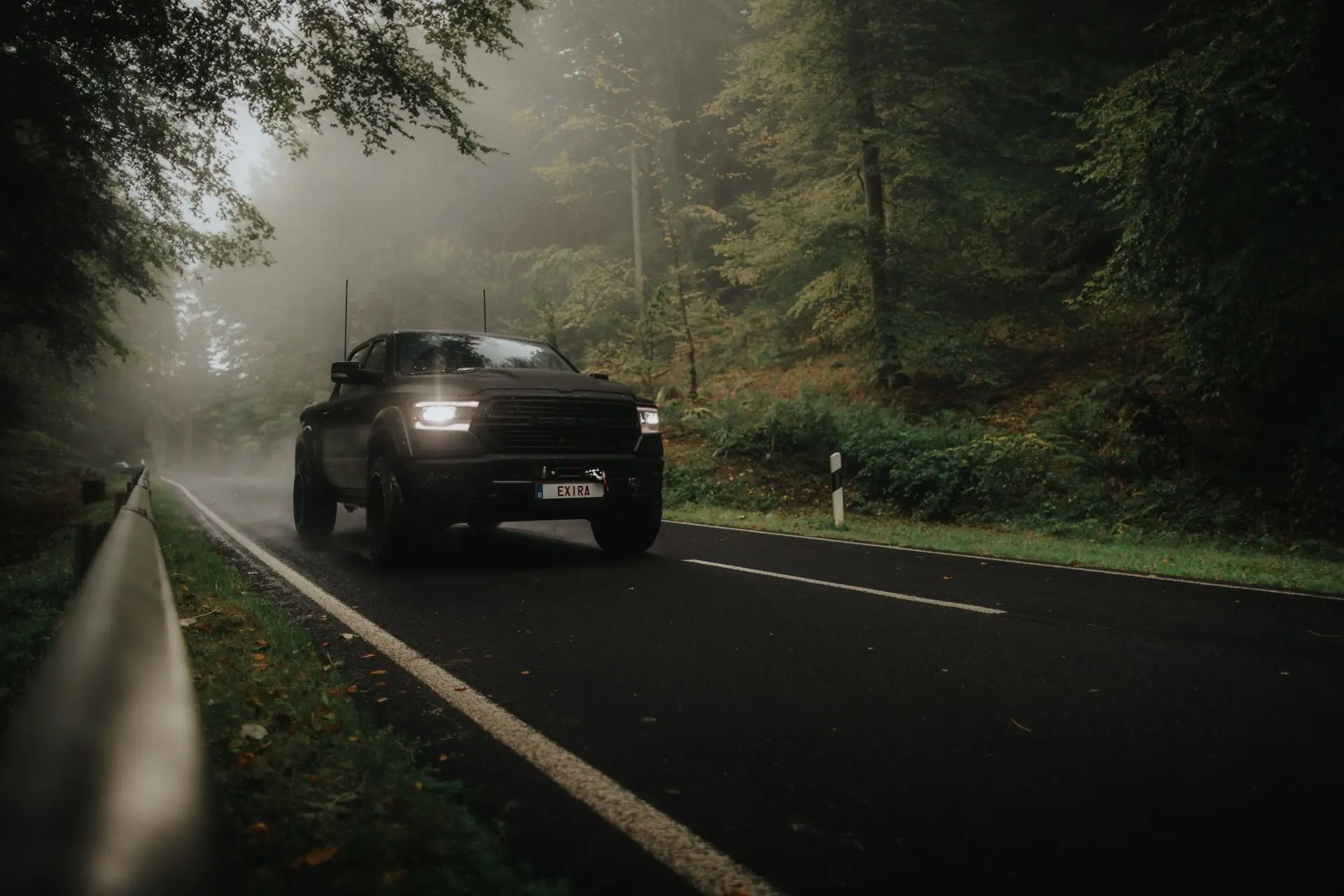 Exira Blacked out dodge ram driving trough foggy forest