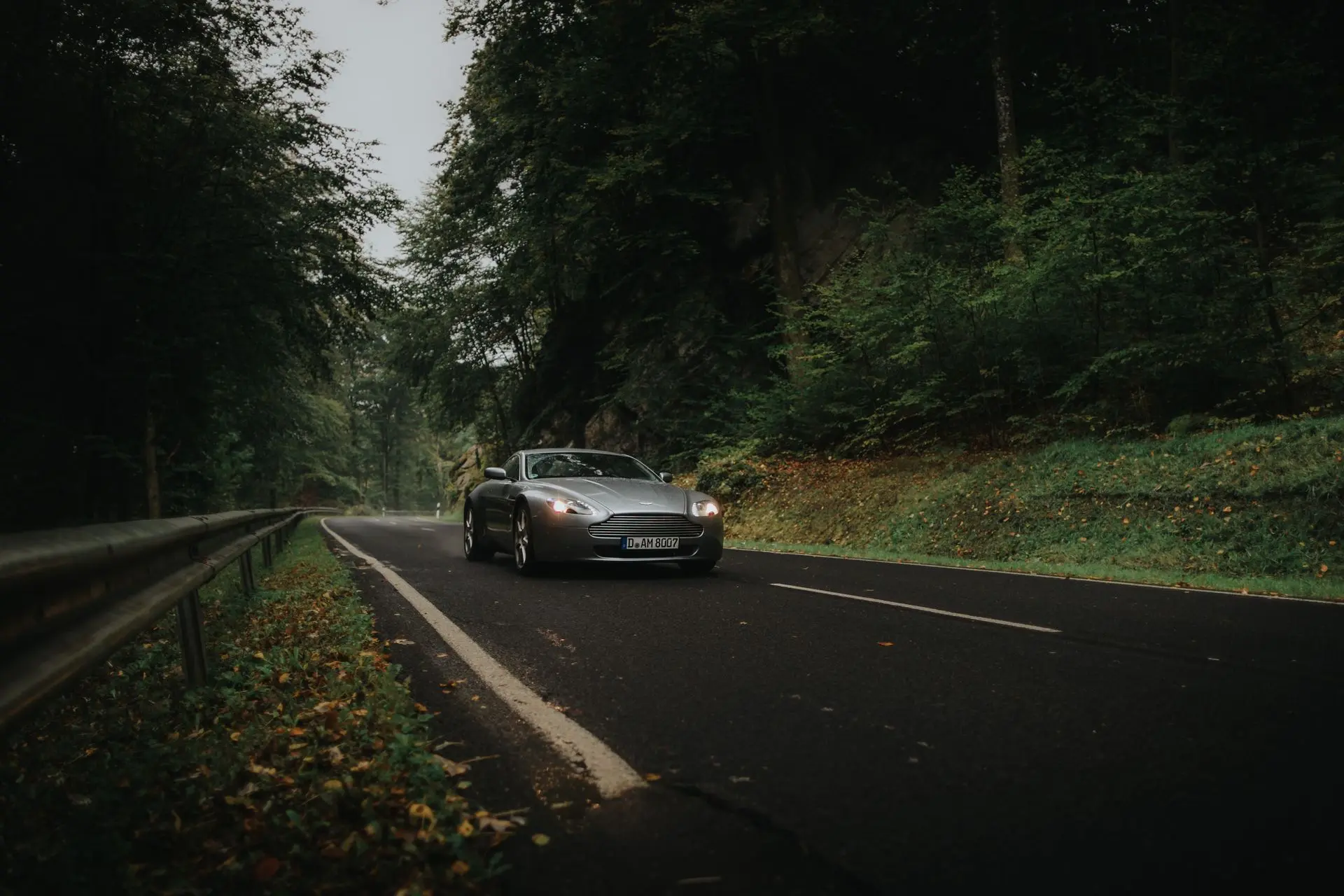 Aston Martin driving on wet road