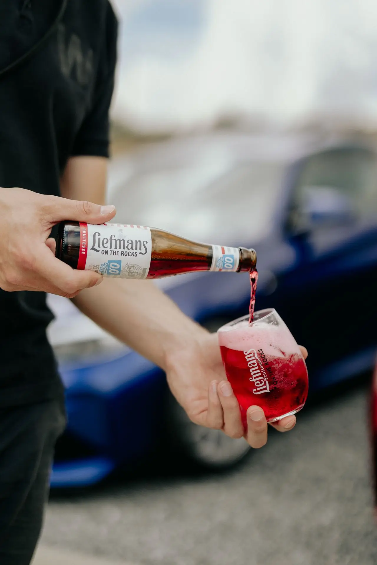 Liefmans 0% on the rocks with bmw sports car in the back