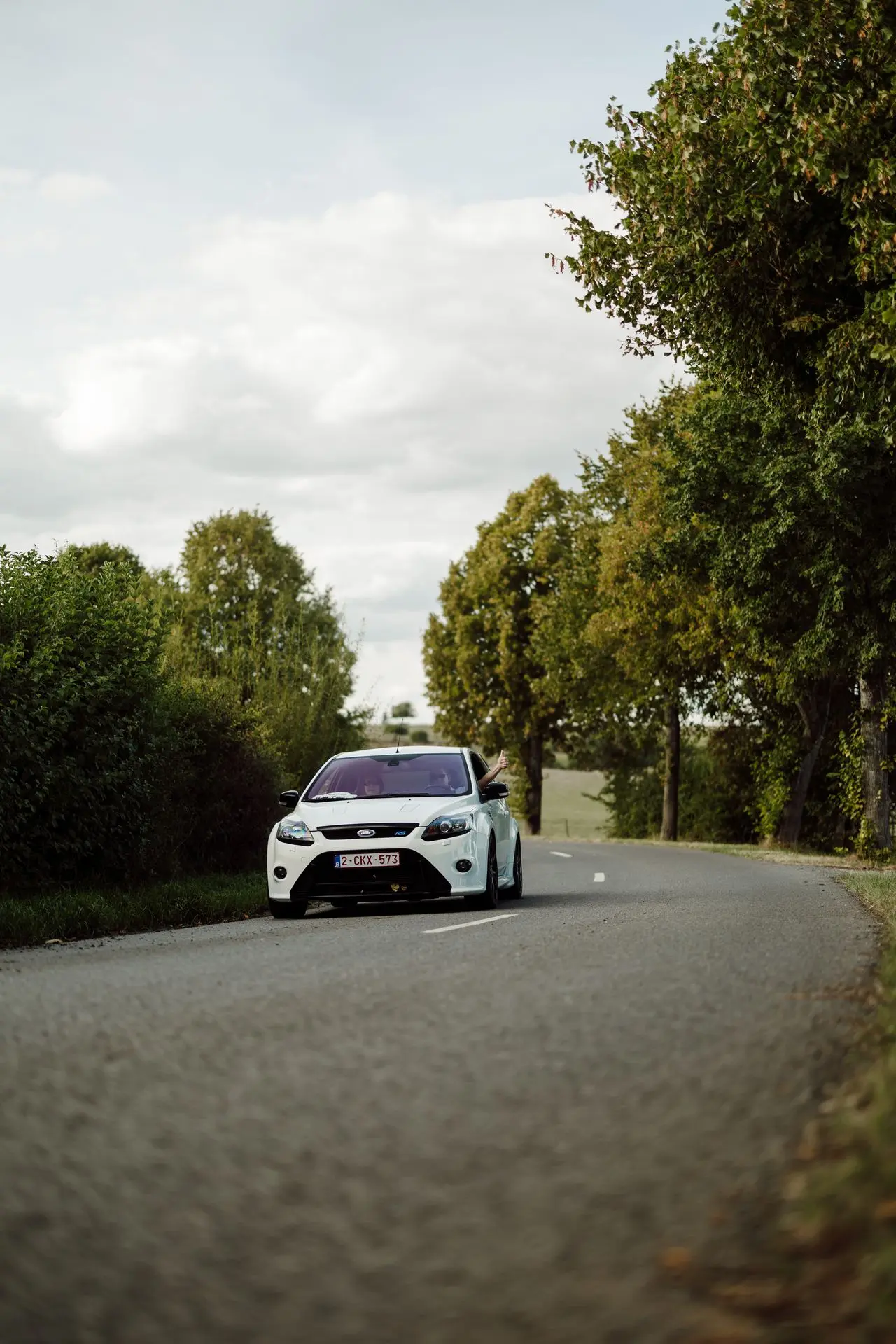 White Ford Focus RS MK2 driving down country road