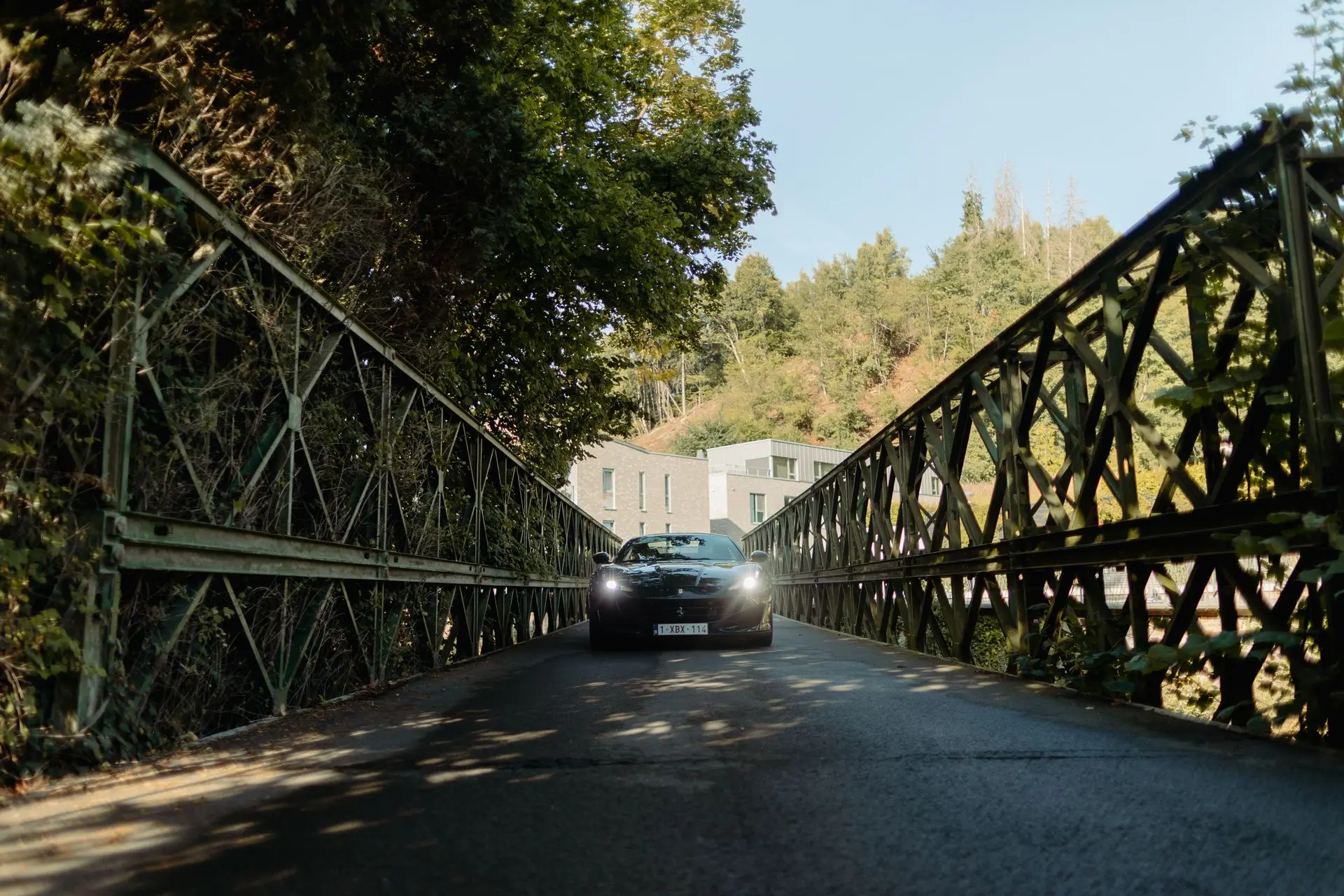 Ferrari driving down old bridge